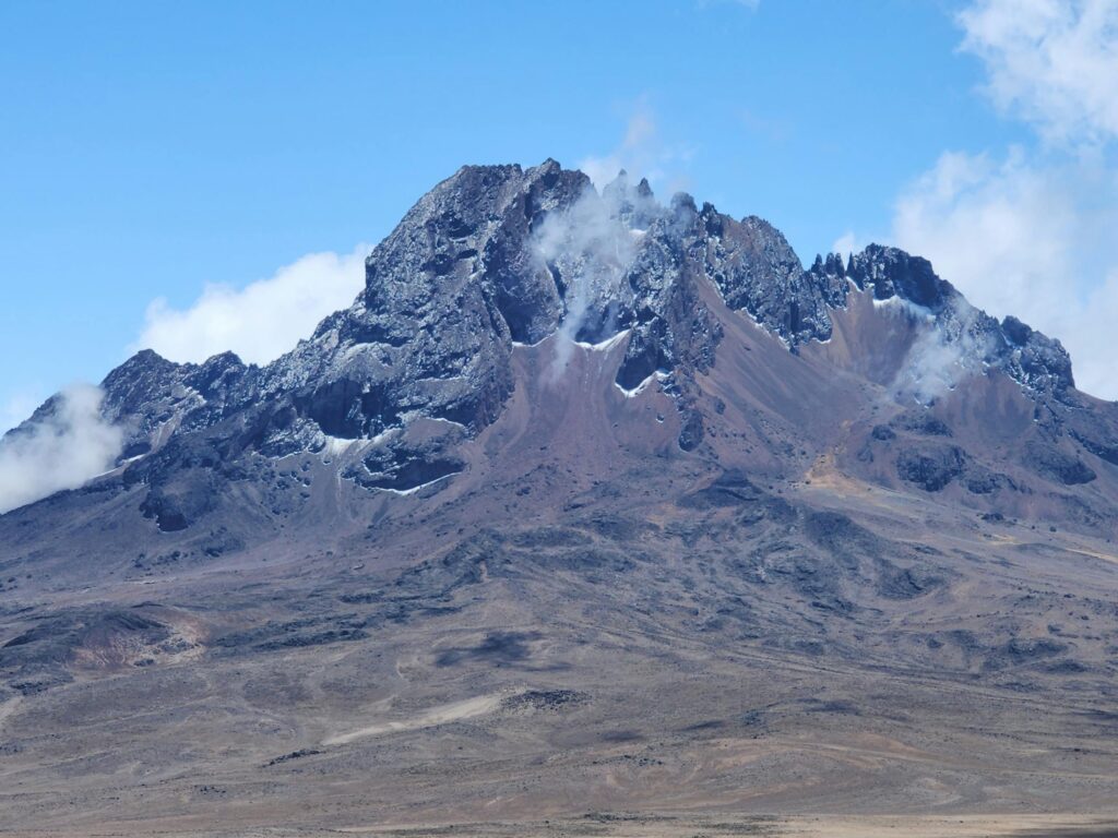 Stunning view of Gilman's Point, Mount Kilimanjaro showcasing rugged landscapes and rocky peaks.